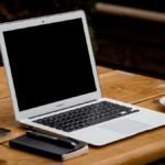 Laptop and coffee on a wooden desk
