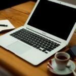 Laptop and notebook on a desk