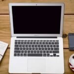 Laptop, phone and coffee on a desk