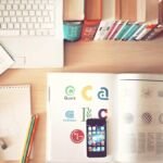 Desk with notebook, phone and office supplies